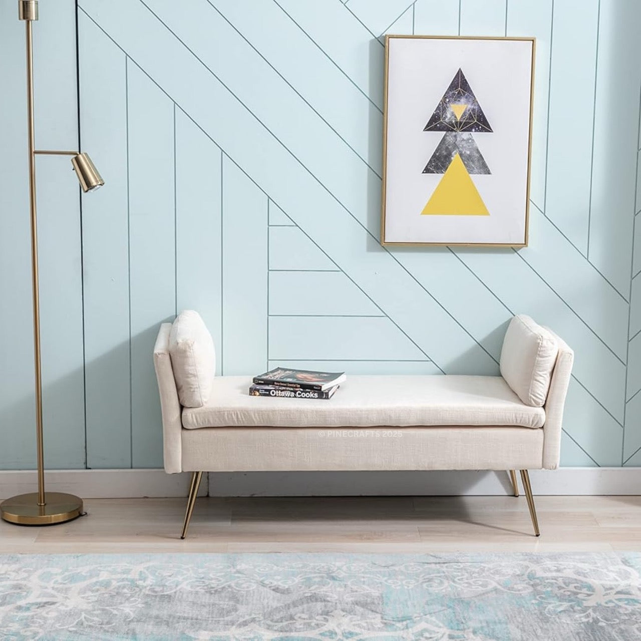 Beige bench against a light blue wall with geometric art and a standing lamp.